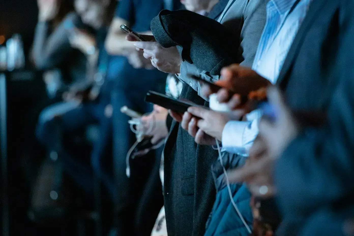 Rad av personer i businesskläder som håller mobiltelefoner, som illustrerar ett sammankopplat nätverk