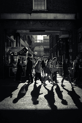 People in transit on a busy street, representing how the people of the organisation are at the core of the Open Strategising method.